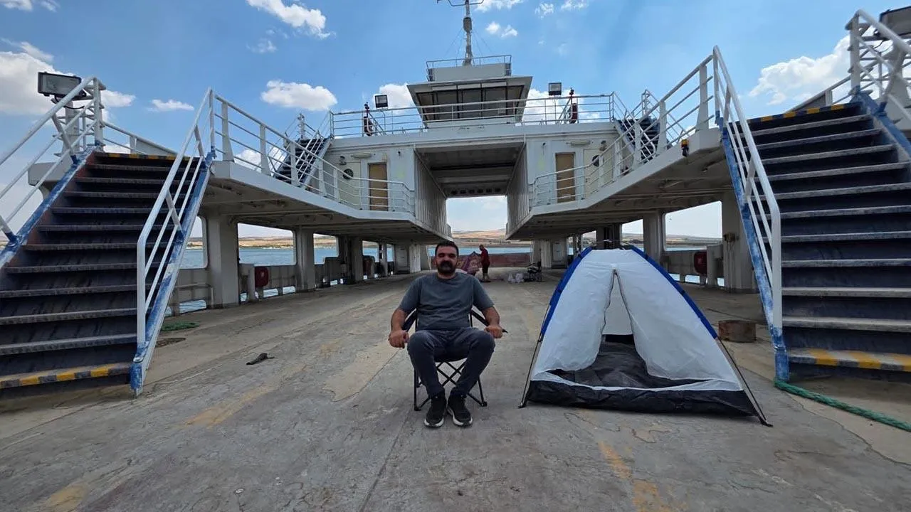 Sit-in protest on the car deck of the idle ferry in Bozova Çatak locality, with a camping chair and tent